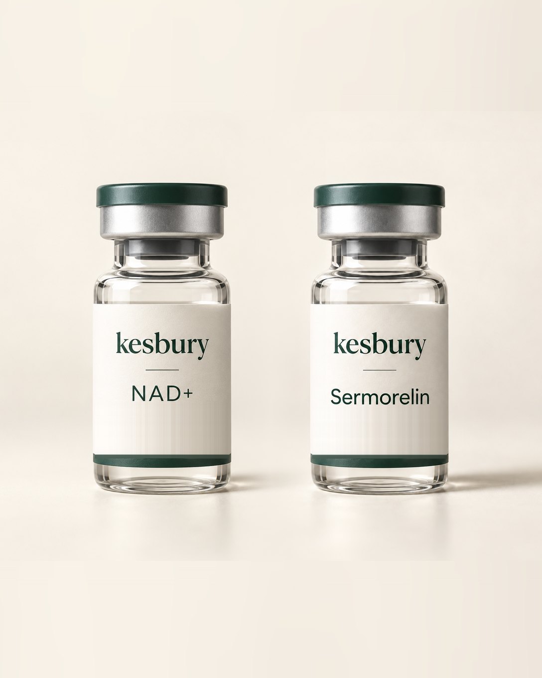 Illustration: two small clear glass vials side by side, each with a dark green cap and a bone label, one reading Kesbury NAD+ and one reading Kesbury Sermorelin, on a plain warm background. A brand concept, not a photograph of the dispensed vials.